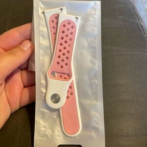 Pink and white Fitbit versa band